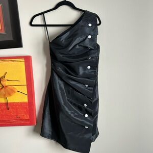 Elegant Black One-Shoulder Dress with white buttons and drapery.